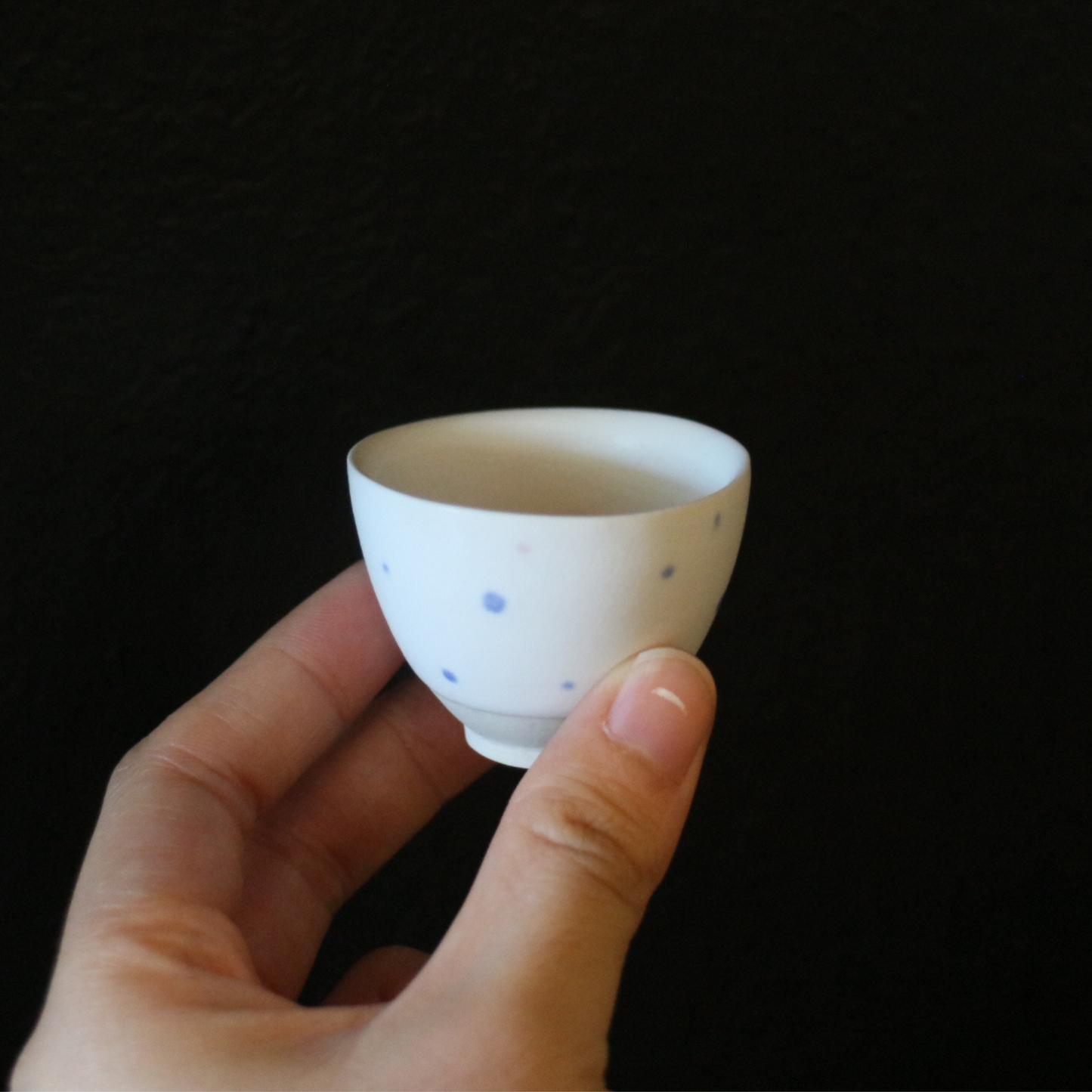 White porcelain blue polka dot tea cup
